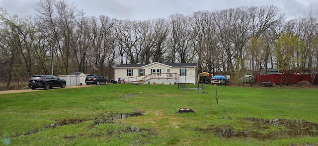 24744 Mound Rd, Dane Prairie Twp, MN 56537 - manufactured / mobile home with a storage shed and an outbuilding
