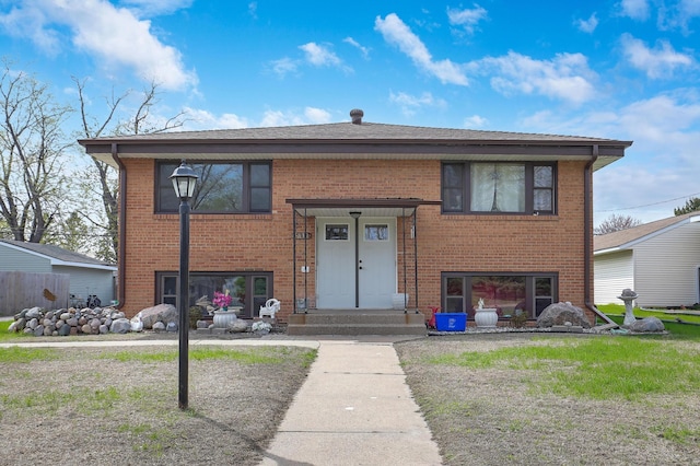 split foyer home featuring brick siding