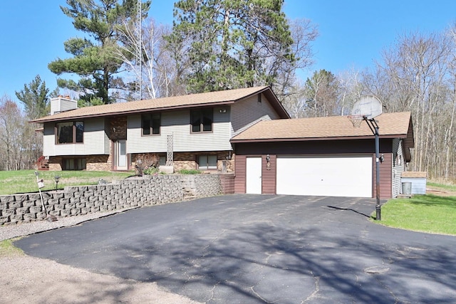 16153 Chestnut Dr, Brainerd, MN 56401 - bi-level home with an attached garage, driveway, and a chimney