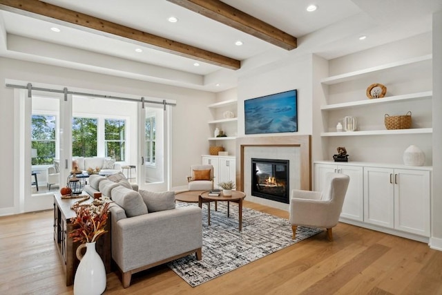 14237 Mckenna Rd NW, Prior Lake, MN 55372 - living area featuring light wood-style floors, a tiled fireplace, recessed lighting, and beam ceiling