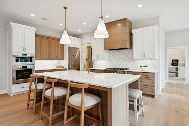 14237 Mckenna Rd NW, Prior Lake, MN 55372 - kitchen with light wood-type flooring, decorative backsplash, a breakfast bar area, and premium range hood