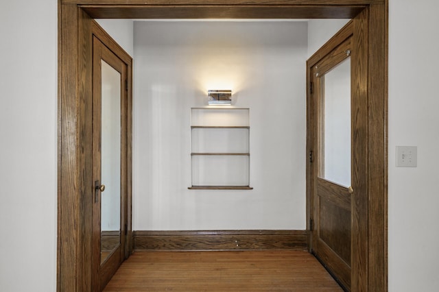 corridor featuring wood finished floors