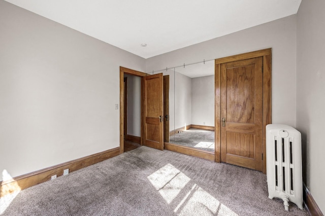 carpeted bedroom featuring baseboards and radiator