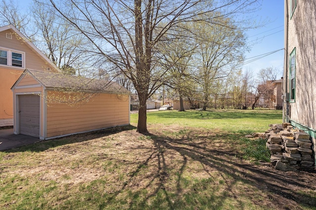 view of yard with a garage and an outdoor structure