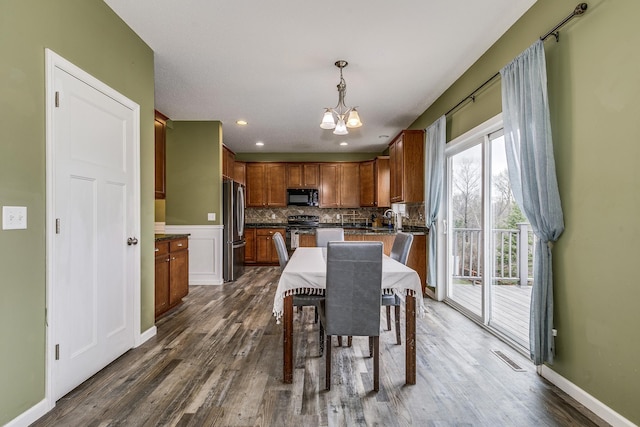 dining space with recessed lighting, baseboards, a chandelier, and dark wood finished floors