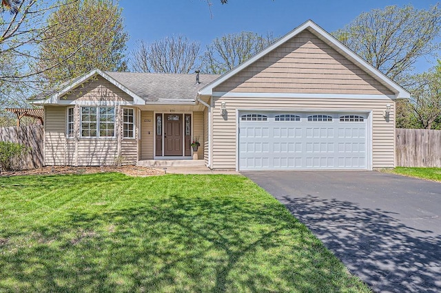 ranch-style home featuring a garage, fence, driveway, a front yard, and roof with shingles