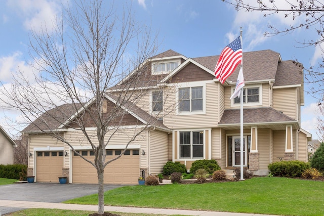 craftsman-style home featuring a garage, a shingled roof, a front lawn, and driveway