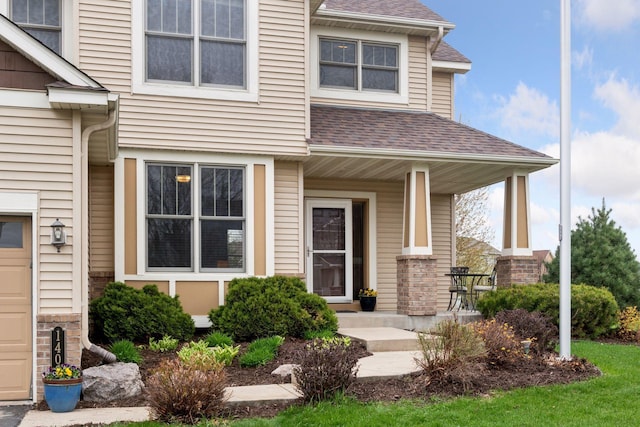 exterior space with roof with shingles and covered porch