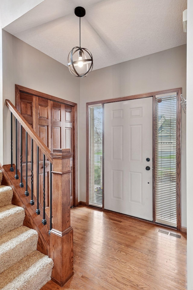entrance foyer featuring a wealth of natural light, light wood finished floors, and visible vents
