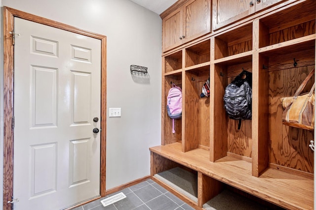 mudroom with dark tile patterned floors, baseboards, a sauna, and visible vents