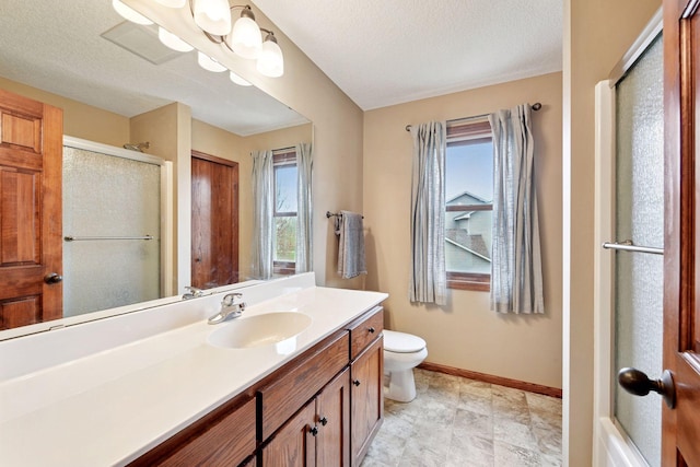 bathroom featuring baseboards, vanity, toilet, and a shower stall