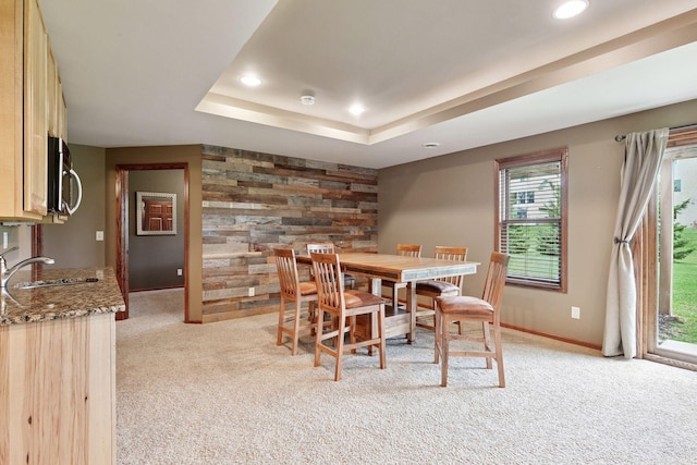 dining room featuring recessed lighting, light colored carpet, and a raised ceiling