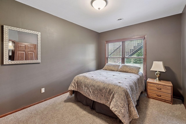 bedroom featuring carpet floors, baseboards, and visible vents