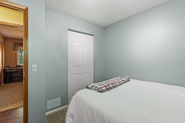 20170 Dunbar Ave, Farmington, MN 55024 - bedroom with a textured ceiling, a closet, baseboards, and carpet flooring