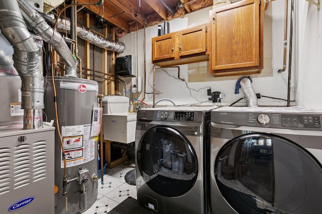 20170 Dunbar Ave, Farmington, MN 55024 - laundry area featuring washer and dryer, cabinet space, and water heater
