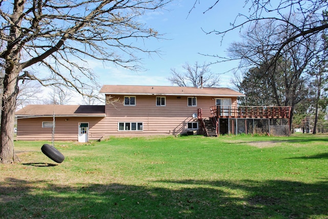 rear view of property with stairs, a lawn, and a wooden deck