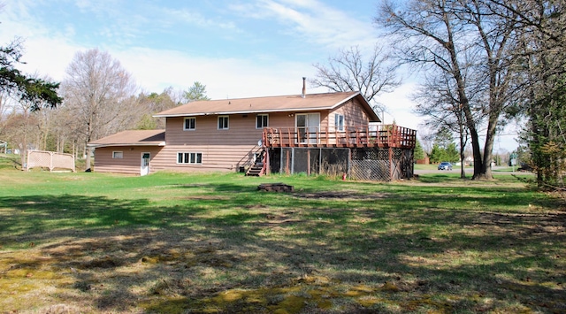 back of house featuring stairs, a yard, and a deck