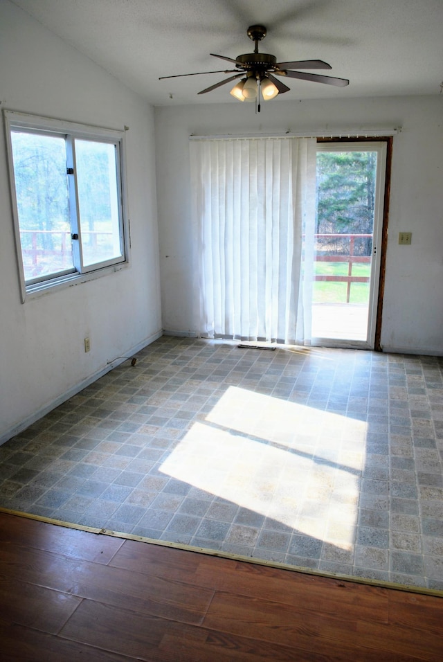 empty room featuring baseboards and ceiling fan