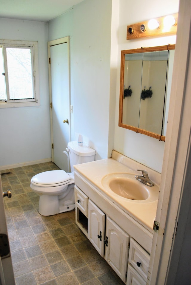 bathroom featuring vanity and toilet