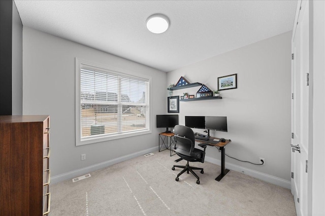 office space with baseboards, visible vents, and carpet