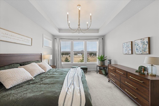 bedroom featuring multiple windows, an inviting chandelier, light carpet, and a raised ceiling