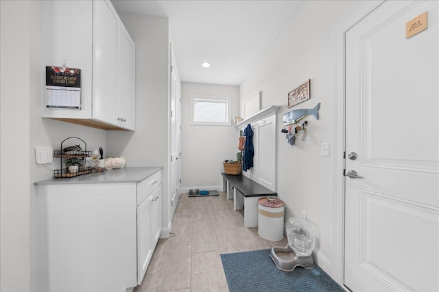mudroom with baseboards and recessed lighting