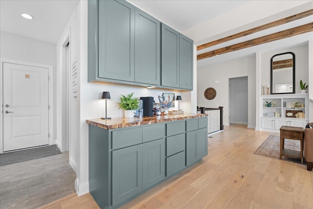 kitchen with recessed lighting, beamed ceiling, baseboards, and light wood-type flooring