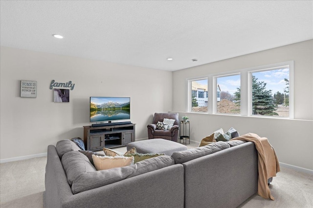living area with recessed lighting, baseboards, light colored carpet, and a textured ceiling
