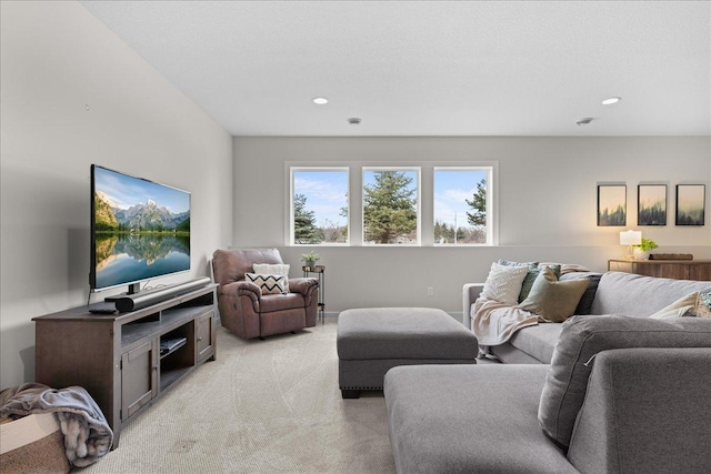 living area featuring recessed lighting and light carpet