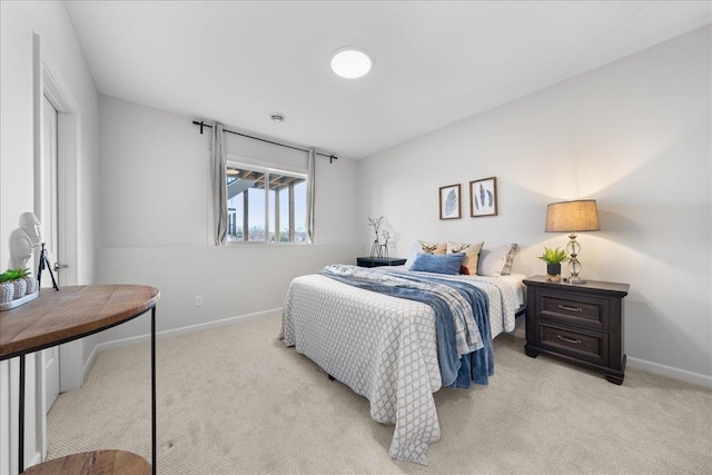 bedroom featuring baseboards and light carpet
