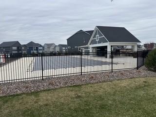 view of swimming pool featuring fence and a residential view