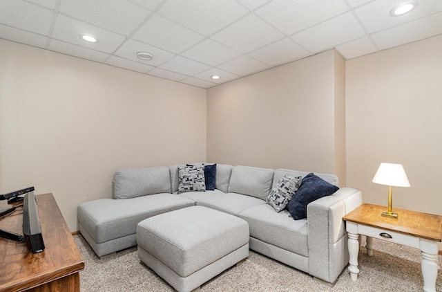 living area featuring a drop ceiling, recessed lighting, carpet floors, and baseboards