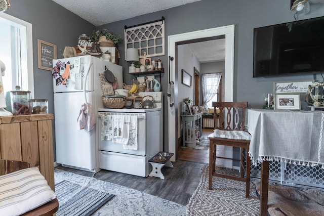 312 Vine St, Fergus Falls, MN 56537 - kitchen featuring a textured ceiling, wood finished floors, and white appliances