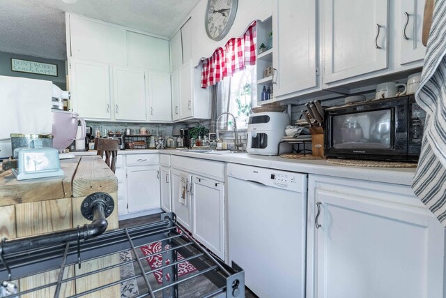 312 Vine St, Fergus Falls, MN 56537 - kitchen featuring a sink, black microwave, light countertops, white dishwasher, and white cabinets