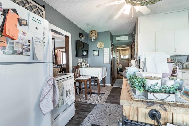312 Vine St, Fergus Falls, MN 56537 - interior space with white appliances, a textured ceiling, dark wood finished floors, a ceiling fan, and white cabinets
