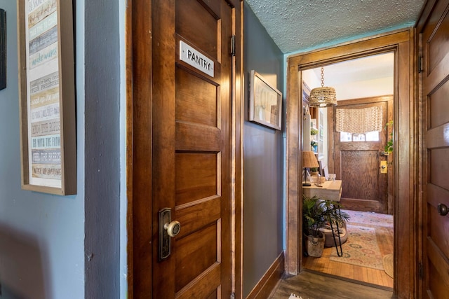 312 Vine St, Fergus Falls, MN 56537 - hallway featuring a textured ceiling, baseboards, and wood finished floors