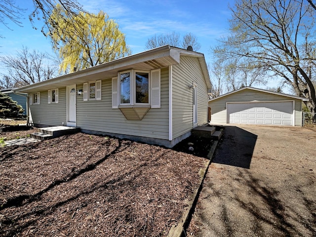 view of front facade with a detached garage and an outdoor structure