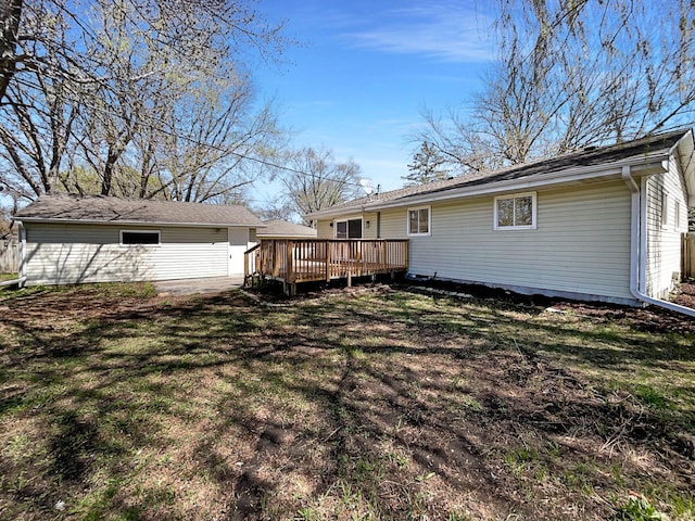 back of property featuring a yard and a wooden deck