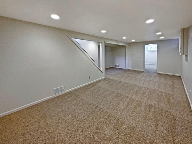 finished basement featuring recessed lighting, baseboards, visible vents, and carpet