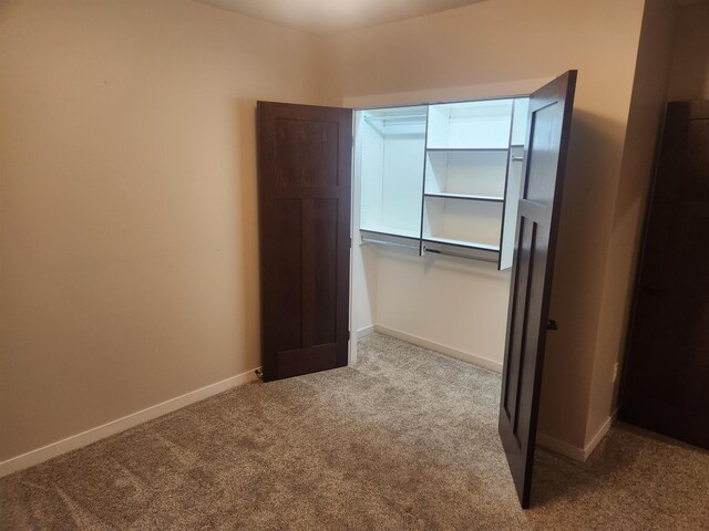 unfurnished bedroom featuring baseboards and carpet