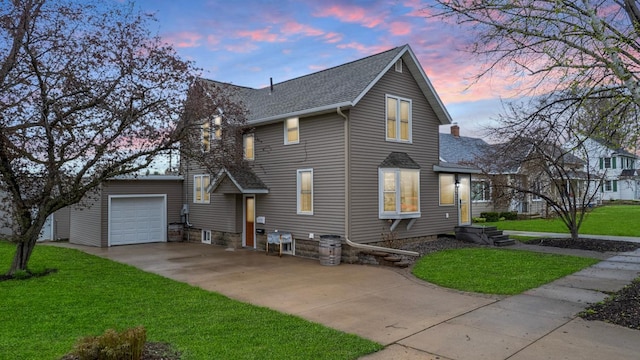621 Fillmore St SE, Chatfield, MN 55923 - traditional-style home featuring driveway, a shingled roof, a front lawn, an attached garage, and a chimney