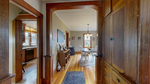 621 Fillmore St SE, Chatfield, MN 55923 - corridor with light wood-style floors and a chandelier