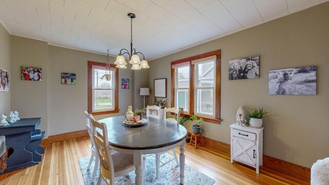 621 Fillmore St SE, Chatfield, MN 55923 - dining space featuring plenty of natural light, light wood-style floors, a chandelier, and baseboards