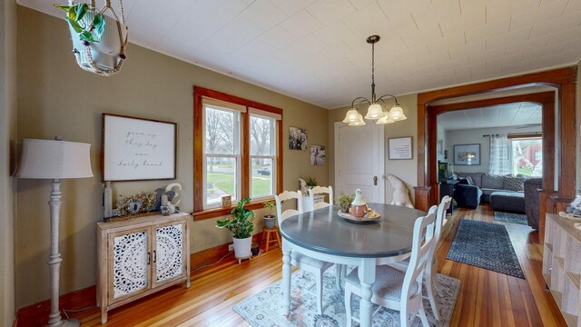 621 Fillmore St SE, Chatfield, MN 55923 - dining space featuring light wood-style floors, plenty of natural light, and a chandelier