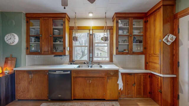 621 Fillmore St SE, Chatfield, MN 55923 - kitchen with dishwasher, a sink, a ceiling fan, and brown cabinets