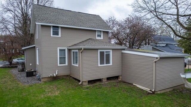 621 Fillmore St SE, Chatfield, MN 55923 - back of property with a shingled roof, a yard, and cooling unit
