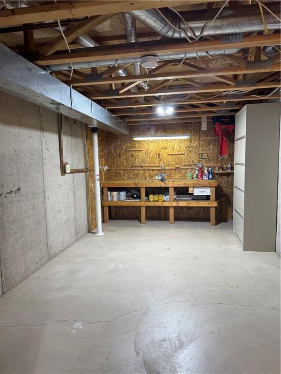 unfinished below grade area with a workshop area