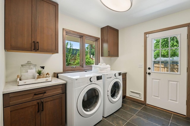 7000 Lanham Ln, Edina, MN 55439 - laundry area featuring cabinet space, washing machine and clothes dryer, and dark tile patterned floors