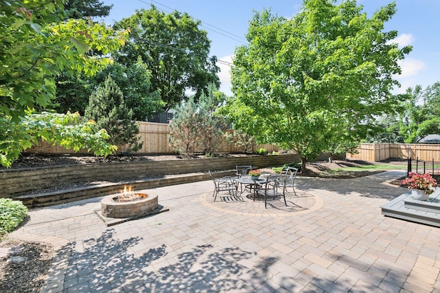 7000 Lanham Ln, Edina, MN 55439 - fenced backyard featuring an outdoor fire pit and a patio