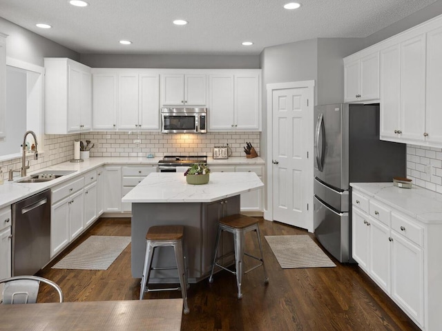 kitchen featuring a sink, white cabinets, and stainless steel appliances